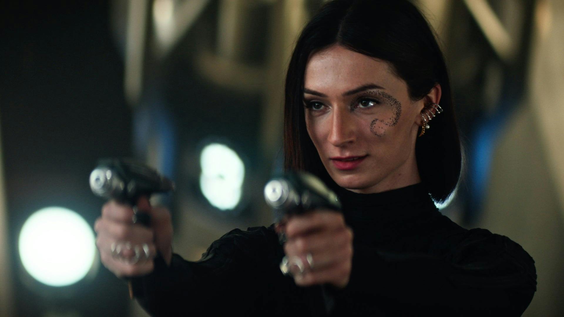 Dr. Aspen holding a phaser in each hand, as seen on Strange New Worlds 